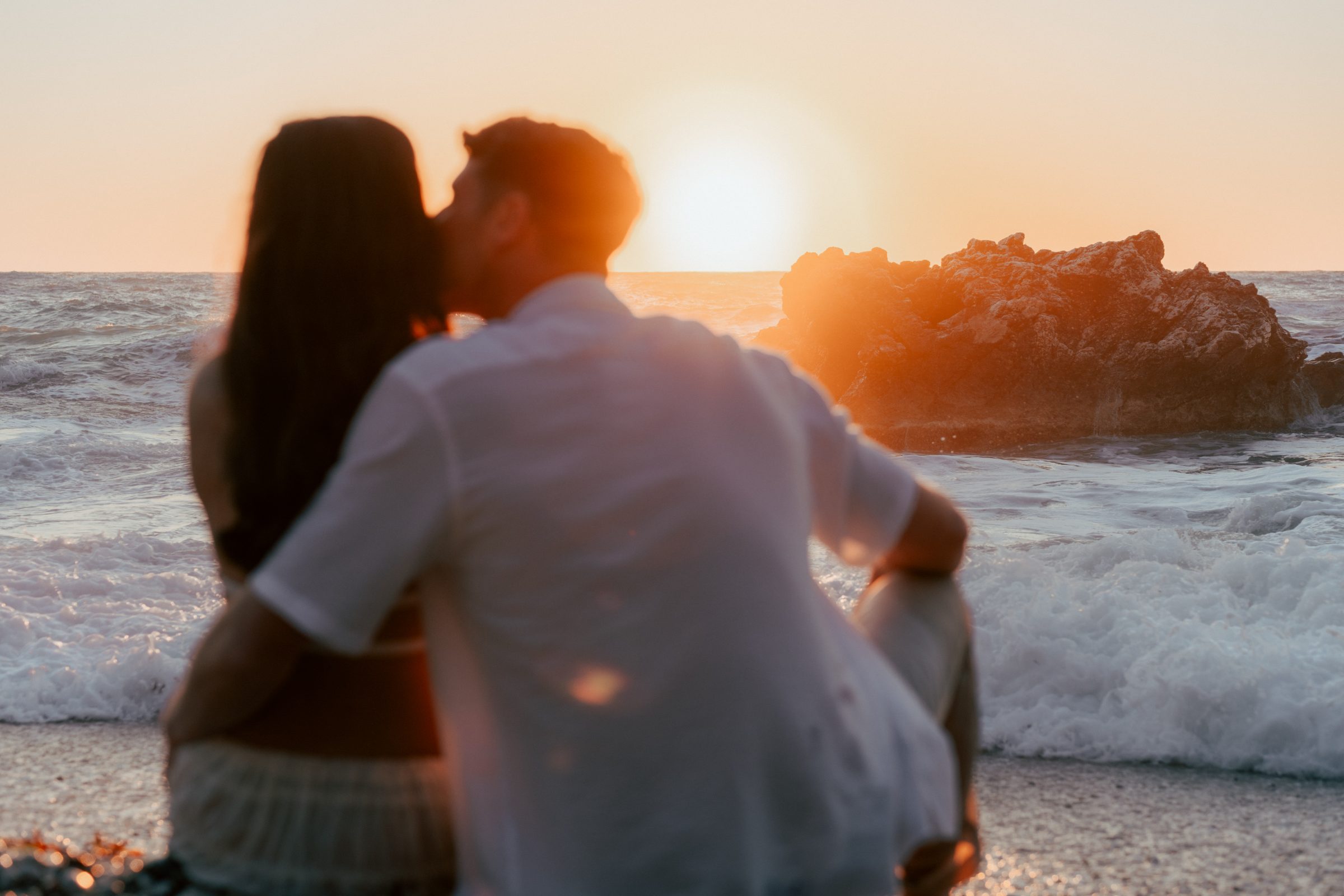 A couple watching the sunset over the sea in Lefkada